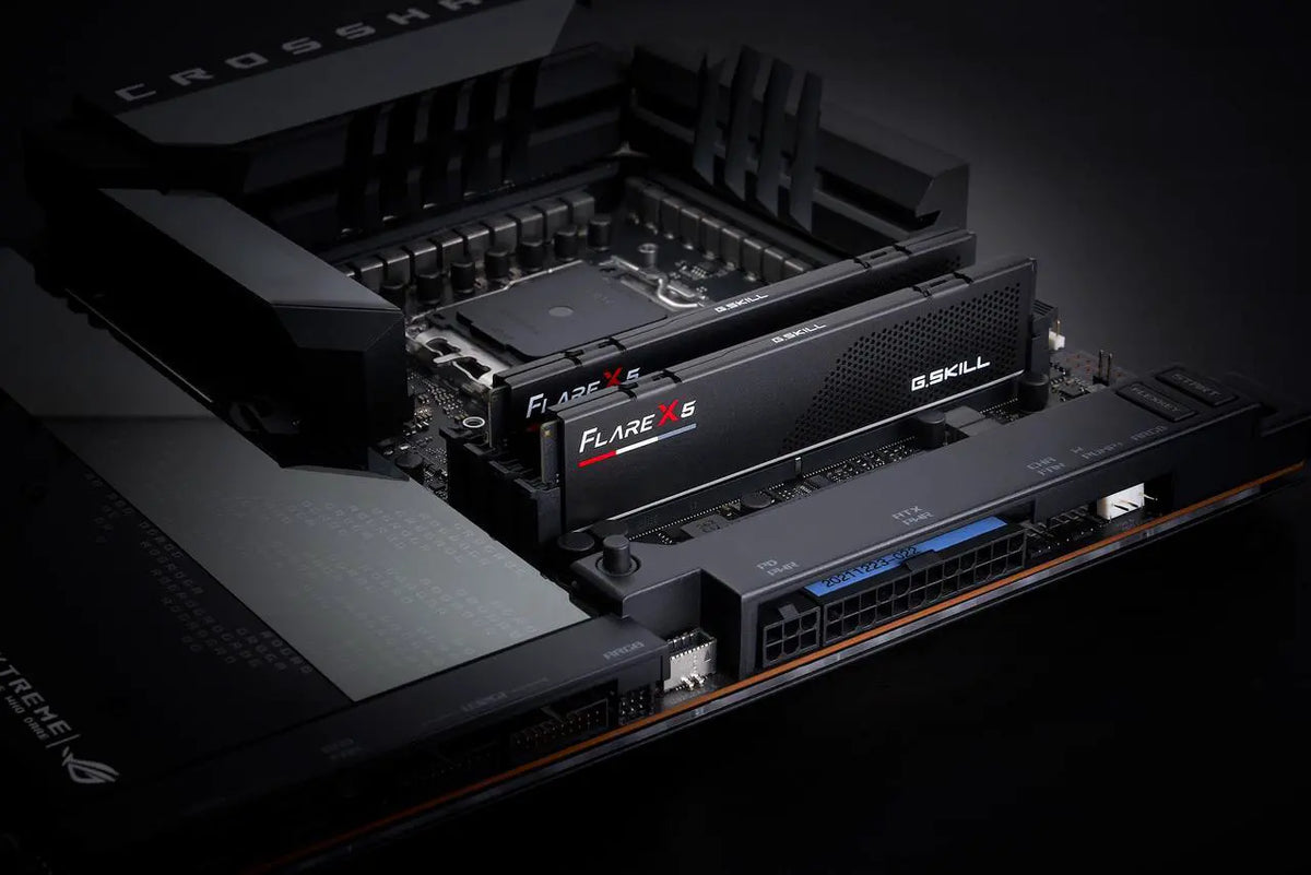 Close-up of a computer motherboard with G.Skill RAM modules on a dark background