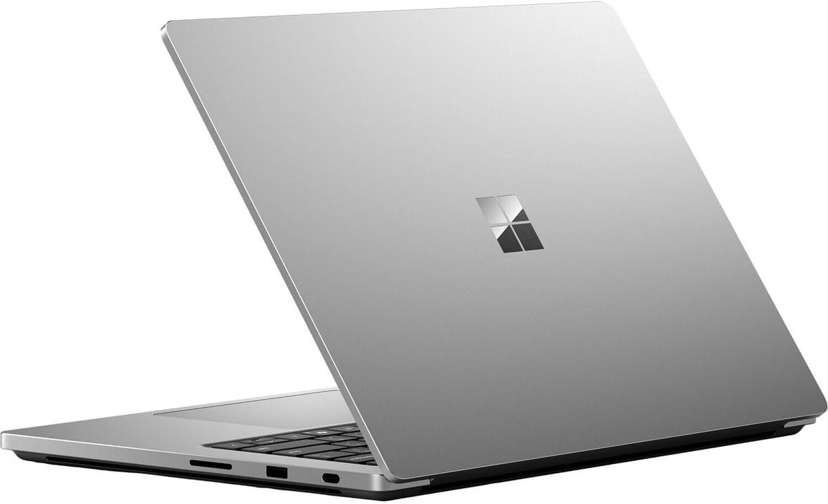 A silver Microsoft Surface laptop shown open at an angle, featuring a metallic silver lid with the Windows logo and a black keyboard base, set against a plain white background.